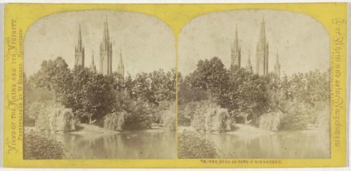 Kurpark in Wiesbaden with the towers of the Market Church in the background, Germany