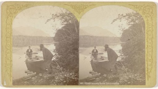 Two men with a rowboat in Upper Ausable Lake in the Adirondack Mountains, United States
