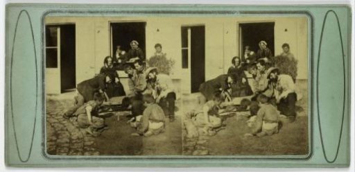 Boys playing in a sandbox in front of a house