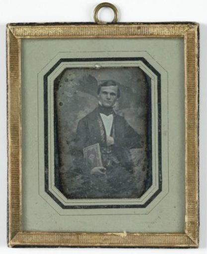 Portrait of an unknown young man with a Bible