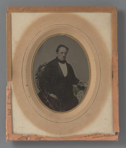 Portrait of a seated man with a book