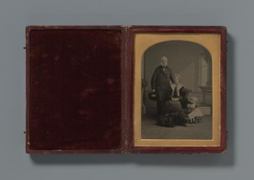 Portrait of an unknown man, woman and child with a dog