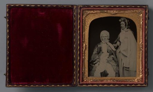 Portrait of two unknown women with caps