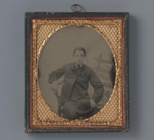 Portrait of an unknown young man with a hat in his hand