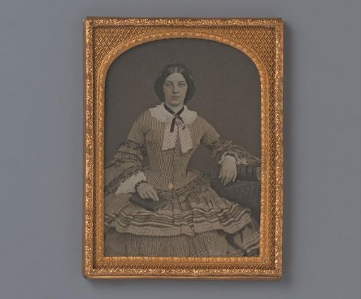 Portrait of a young woman with a book on her lap