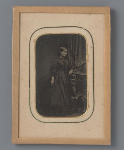 Portrait of an unknown woman with album