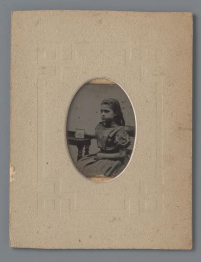 Portrait of an unknown girl with photograph