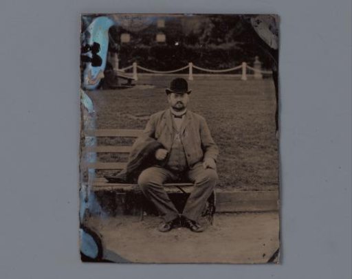 Portrait of an unknown man on a bench in a park
