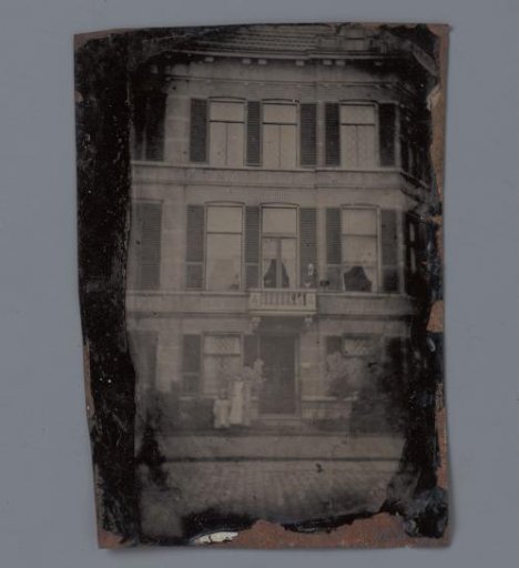 View of a house with several persons in front of it