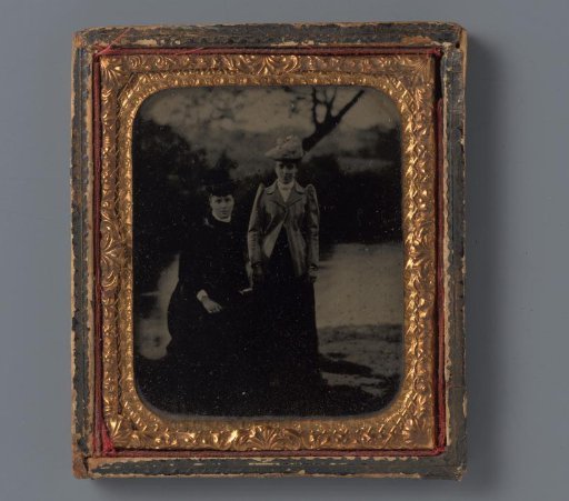 Portrait of two unknown women with hats by the water