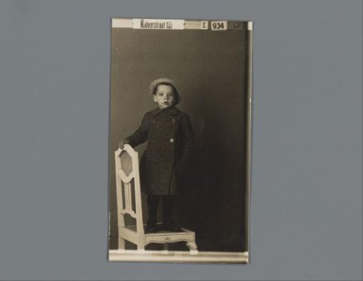 Portrait of an unknown child on a chair