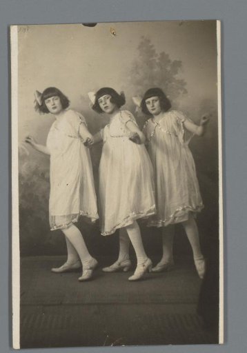 Three unknown young women posing, all in identical dresses