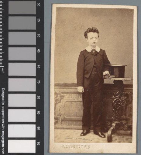 Portrait of an unknown boy, standing beside a table on which a tall hat and a book lie