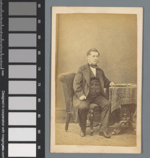 Portrait of an unknown man, sitting at a table