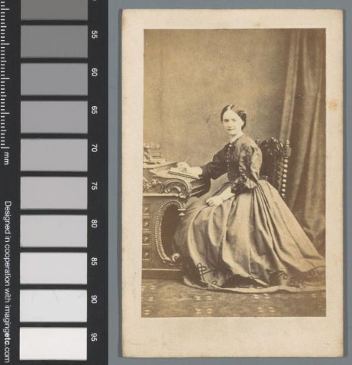 Portrait of an unknown woman sitting at a desk