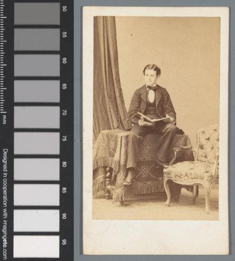 Portrait of an unknown boy, seated on a table with an open book in his hands