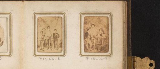 Photographic reproduction of three unknown children by a wooden fence in a forest
