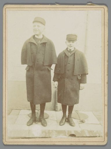 Portrait of Two Unknown Standing Boys in Coats