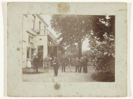 Nine Young Men on the Yard Near a House, in the Foreground an Amateur Photographer