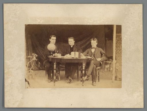 Group Portrait of Three Unknown Men at a Table with Books and a Globe
