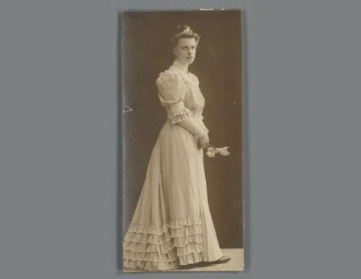 Portrait of an unknown young woman in a dress with a bouquet