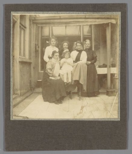 Family portrait with unknown women on a courtyard