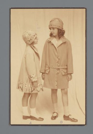 Two models with embroidered jackets and caps from the Wiener Werkstätte