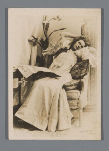 Portrait of an unknown woman, leaning back with a newspaper on her lap, advertisement for Mafiadis et Cie