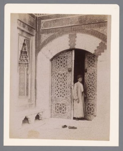 Unknown man in the doorway of a mosque, possibly in Turkey