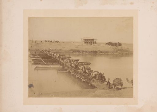 Caravan with camels or dromedaries on a pontoon bridge