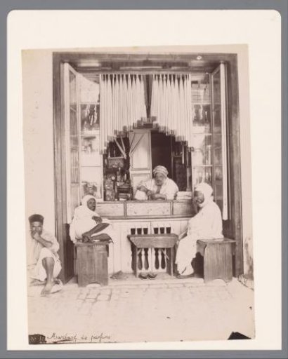 Perfume seller in his shop, presumably in Tunis.