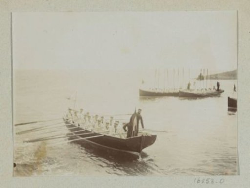 Sailors rowing towards their ship