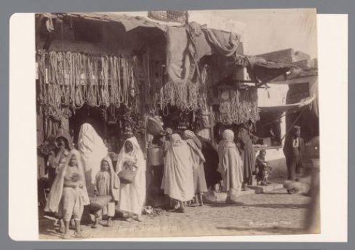 Grocers' shops with customers, presumably in Tunis