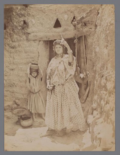 Unknown woman with a spinning wheel, a child behind her