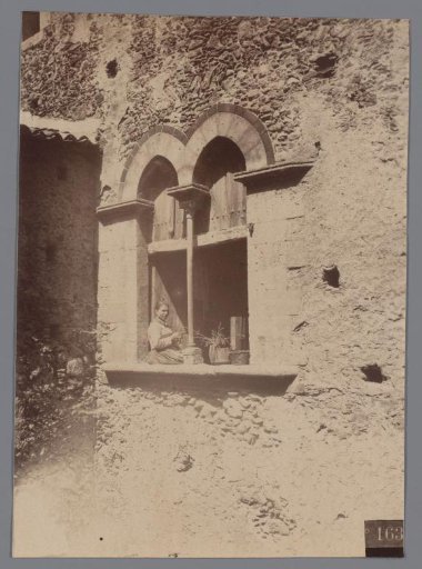 Unknown woman in a window, presumably in Italy