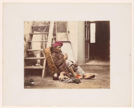 Man with pipe leaning against a staircase