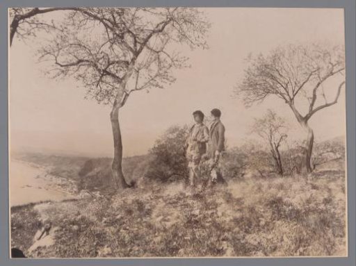Two boys walking arm-in-arm on a hill, possibly Sicily