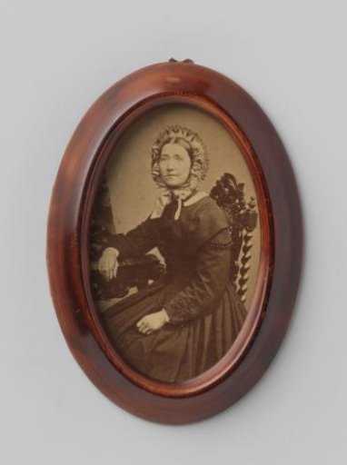Portrait of an unknown seated woman with a cap