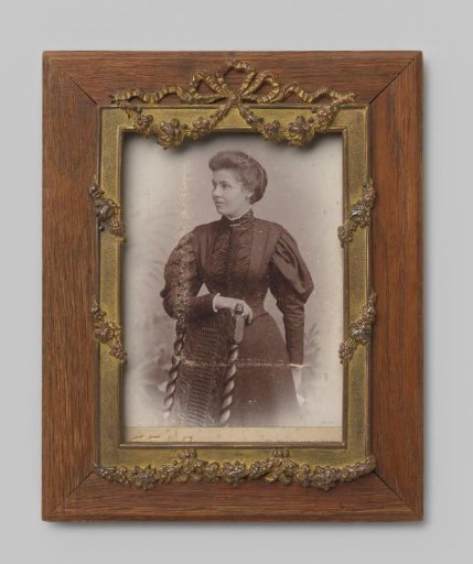Portrait of an unknown woman leaning on the back of a chair