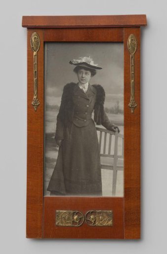 Portrait of an unknown woman with a hat, leaning on a bench