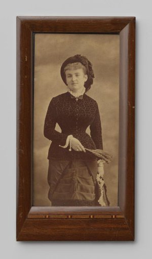 Portrait of an unknown woman with a hat and feather in her hand