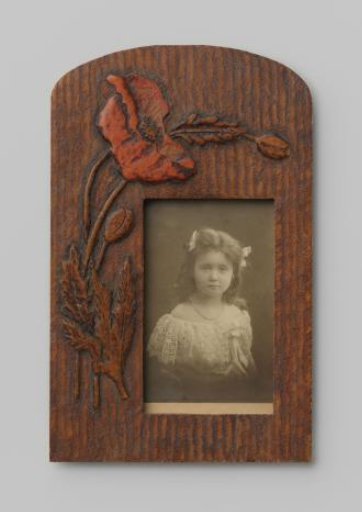Portrait of an unknown girl with a necklace and bows in her hair