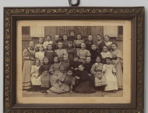 Group portrait of 27 unknown girls and a woman