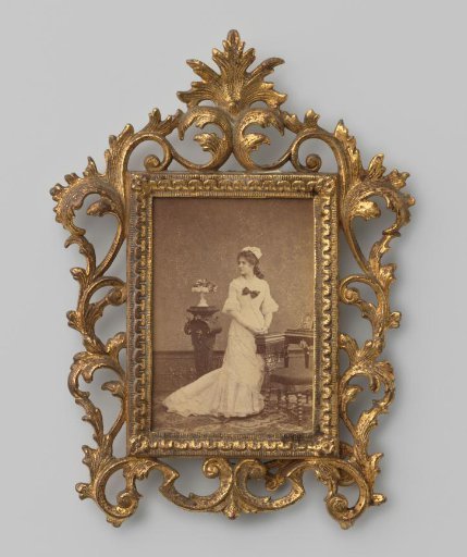 Portrait of an Unknown Standing Woman in a Japanese Dress with Train at a Pedestal, Chair, and Table