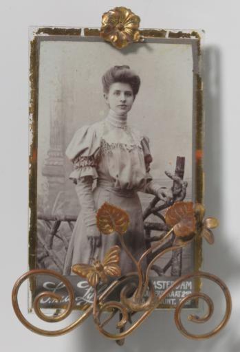 Portrait of an unknown young woman by a fence