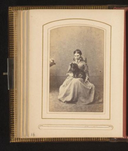 Portrait of a seated woman with a dog on her lap