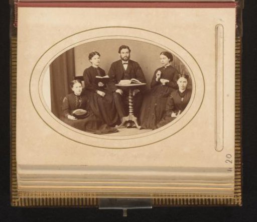Portrait of a man and four women around a table