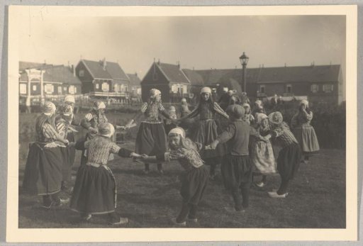Dancing children in costume in a circle on Marken