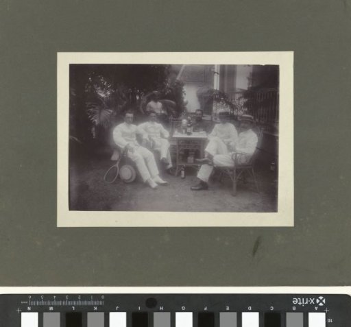 Group Portrait of Five Unknown Men Sitting at a Table, with a Standing Servant, Dutch East Indies