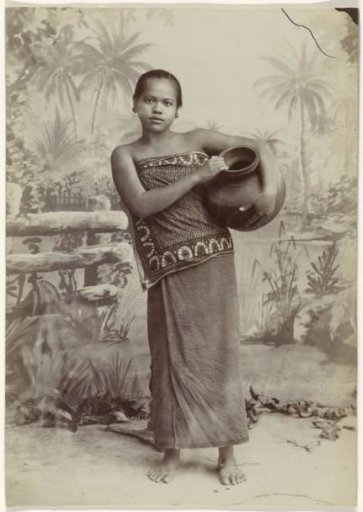 Studio portrait of an unknown Javanese woman with a jug